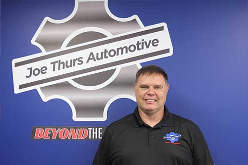 Smiling man at Joe Thurs Automotive shop