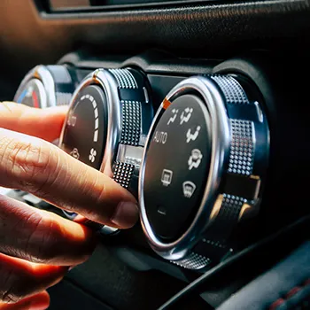 Hand adjusting car air conditioning dials